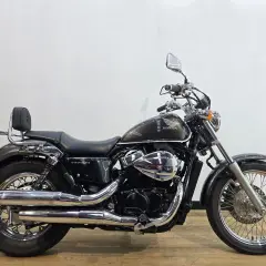 Honda VT750S cromata e scura, con sella nera e schienalino per il passeggero.